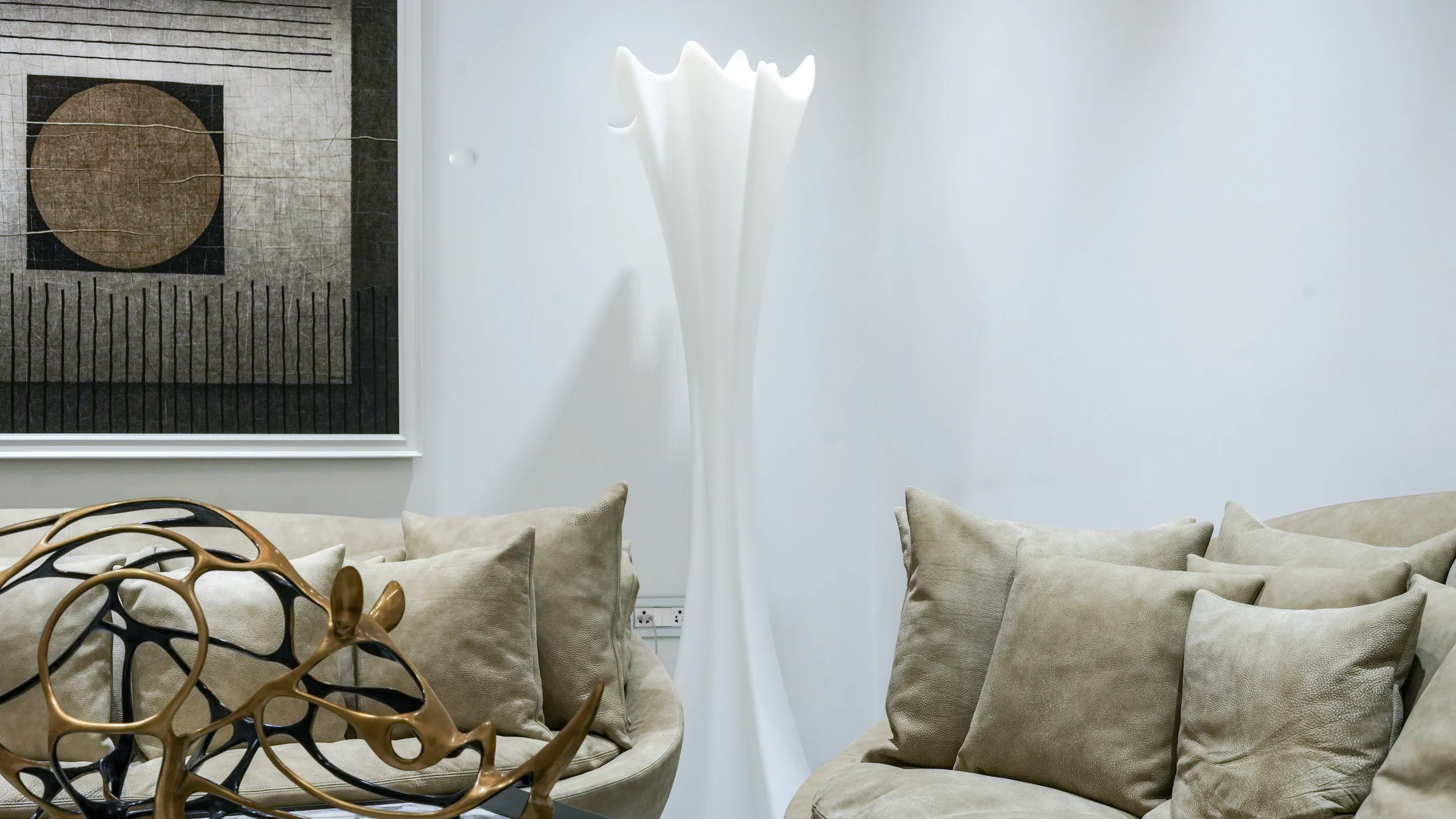 Luxury furniture showroom with premium sofa and sculptural decor